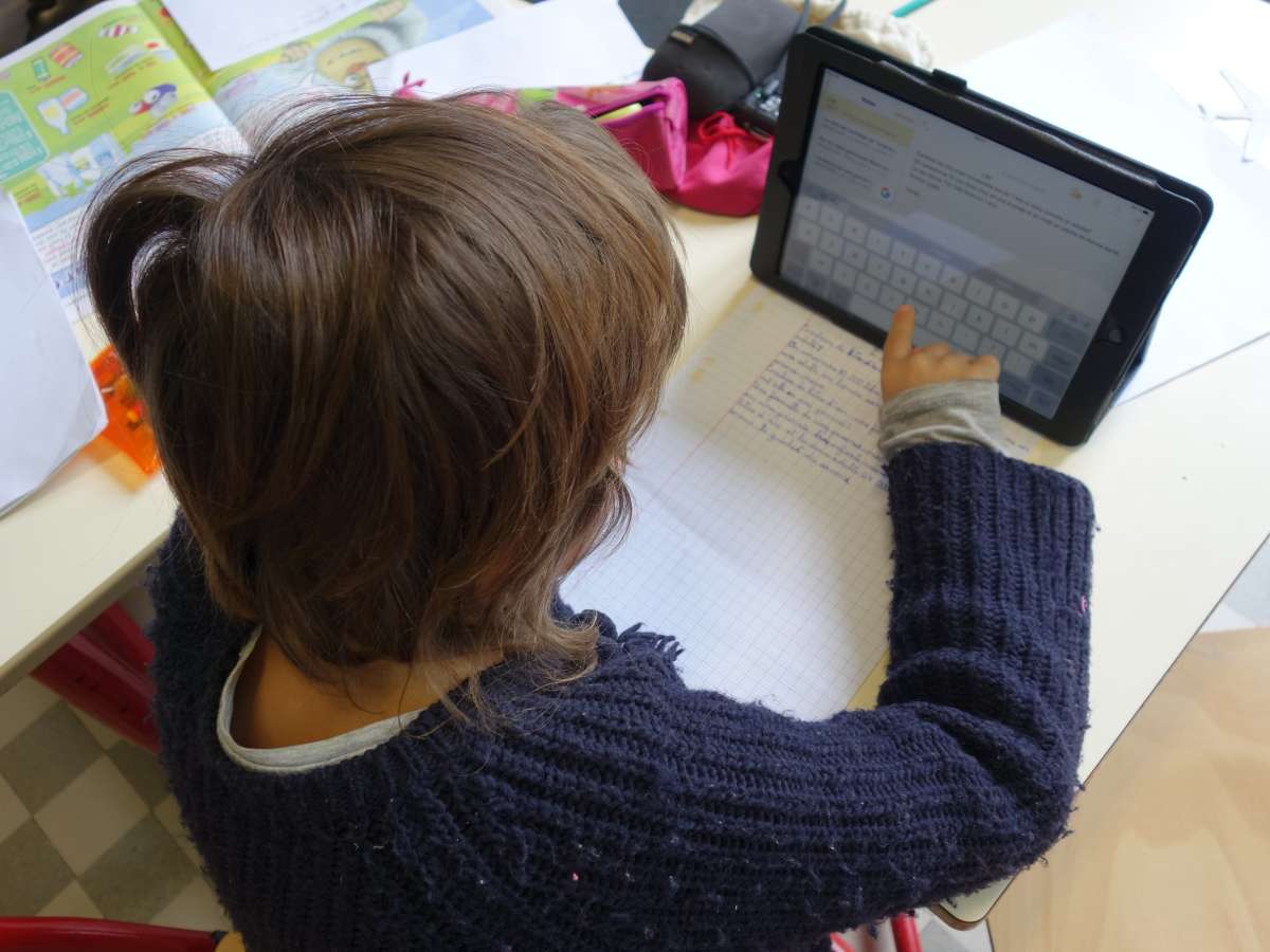 After handwriting a draft of her article, Serena types it on the tablet