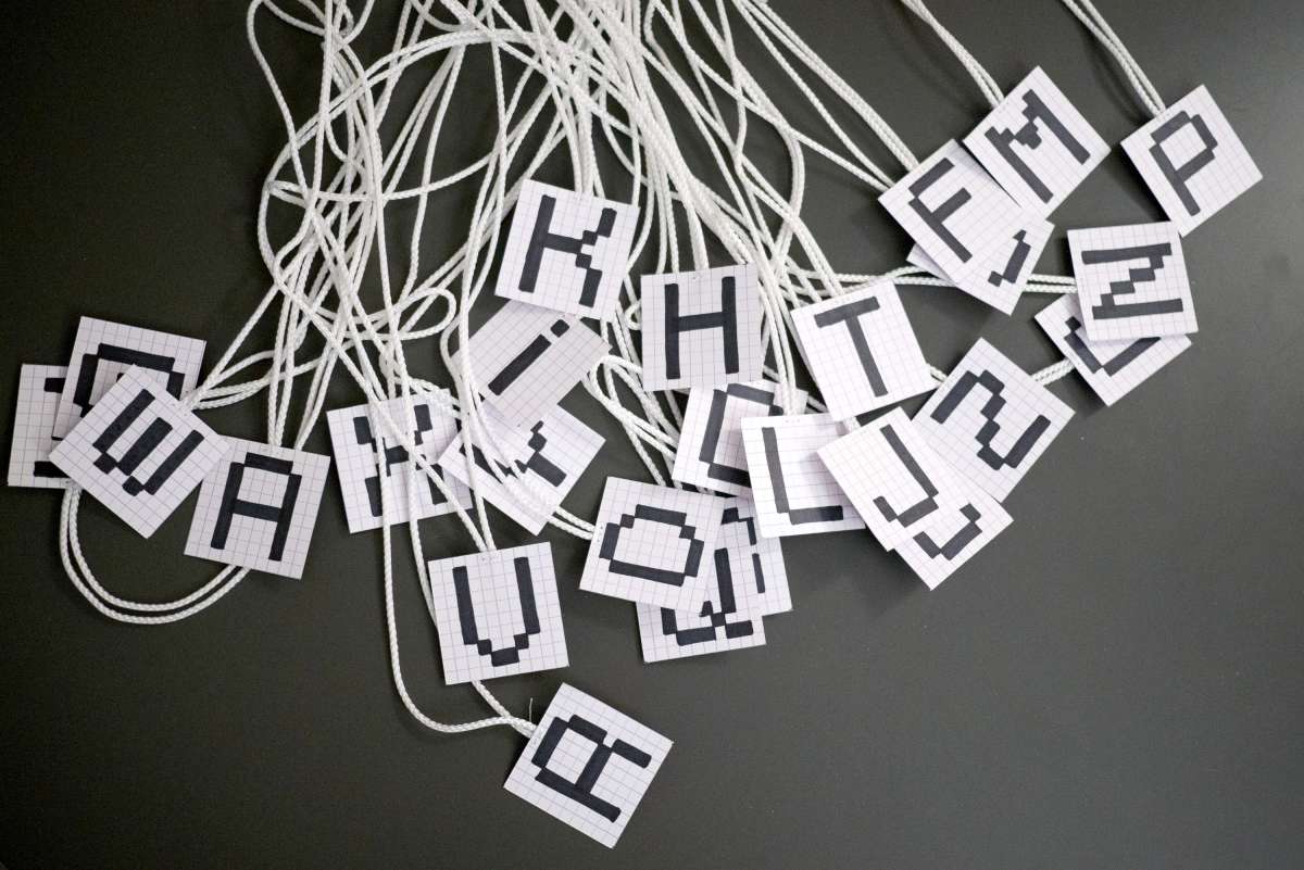 The badges used to assign the letters to the children.