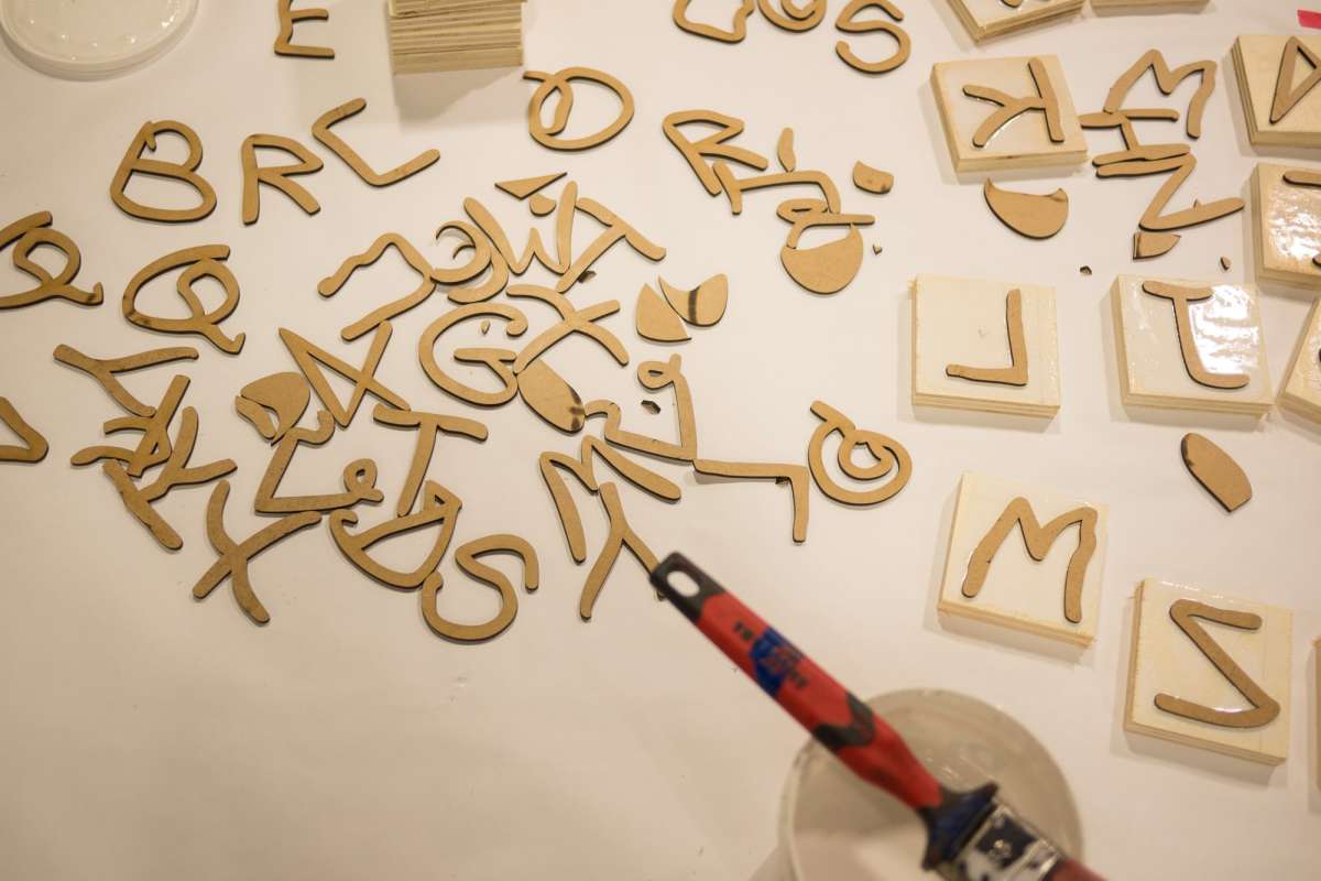 All the laser-cut shapes. 10&times;10cm wooden squares are then coated with wood glue and the shapes are glued on them upside down to make stamps.
